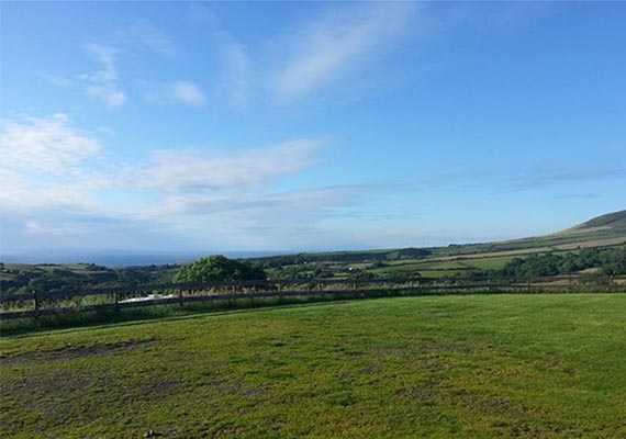 Terraced hard standings for campervans & caravans, looking North West towards Kirk Michael.