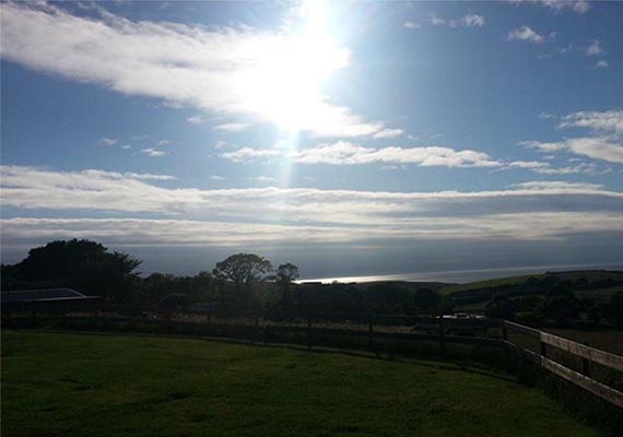 Terraced hard standings for campervans & caravans, looking West towards the Irish Sea and Scotland.